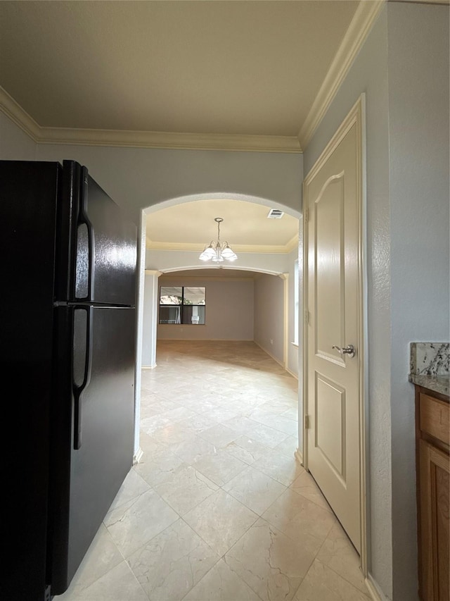 interior space featuring visible vents, arched walkways, marble finish floor, an inviting chandelier, and ornamental molding