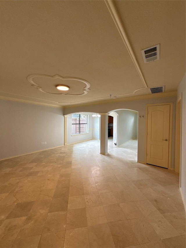 unfurnished room with arched walkways, baseboards, and visible vents