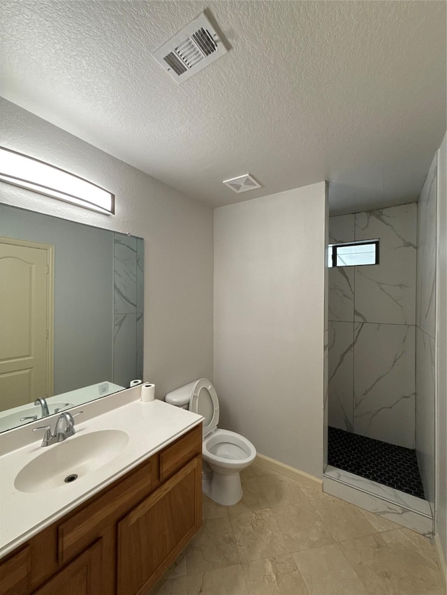 full bathroom featuring a marble finish shower, vanity, toilet, and visible vents