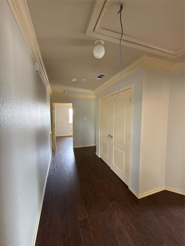 corridor with baseboards, ornamental molding, dark wood-style floors, and visible vents