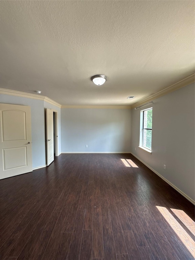 empty room with crown molding, dark wood-style flooring, and a textured ceiling
