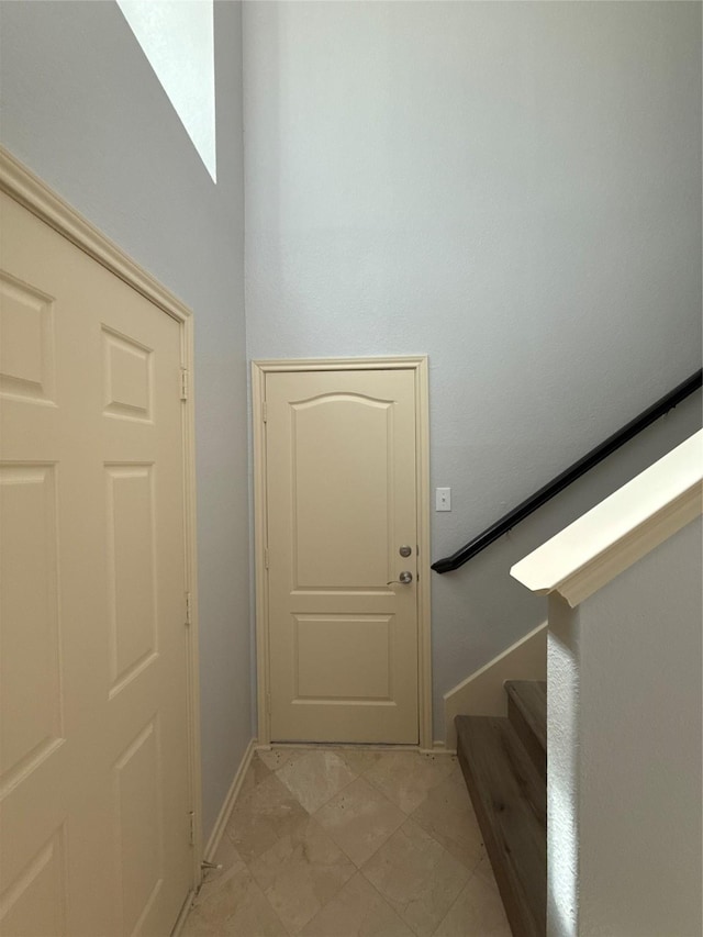 entryway with stairway and baseboards
