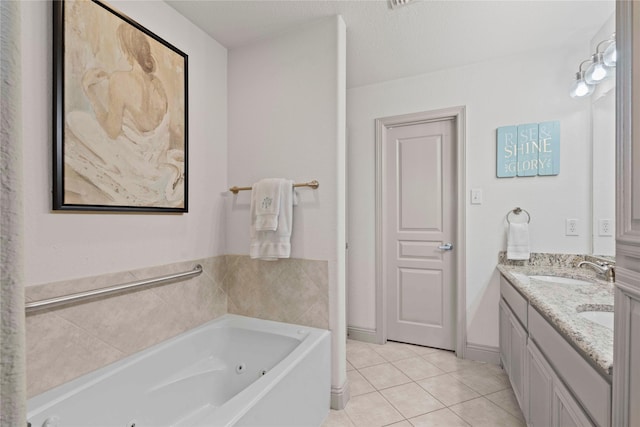 bathroom with double vanity, tile patterned floors, a sink, and a jetted tub