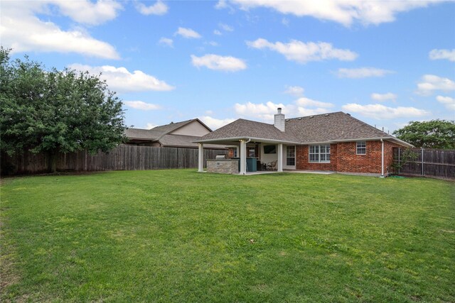 ranch-style house featuring brick siding, fence, a front lawn, concrete driveway, and an attached garage
