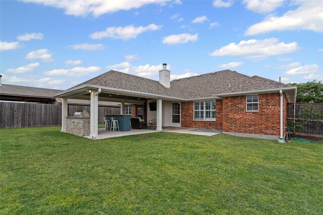 rear view of property with a patio, a fenced backyard, and a chimney