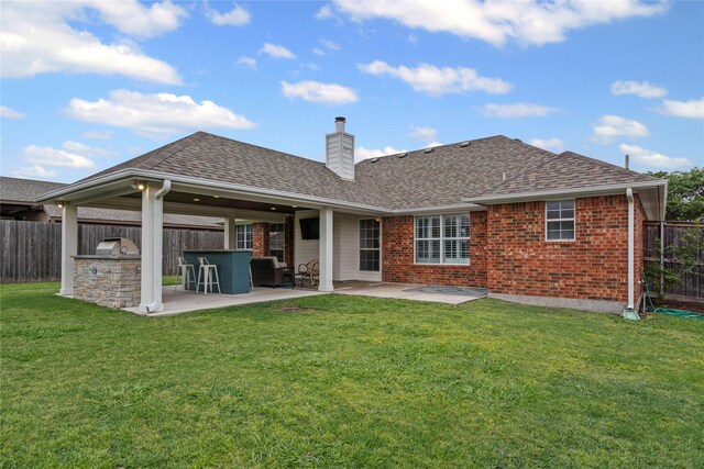 rear view of house with a fenced backyard, a patio area, and a chimney