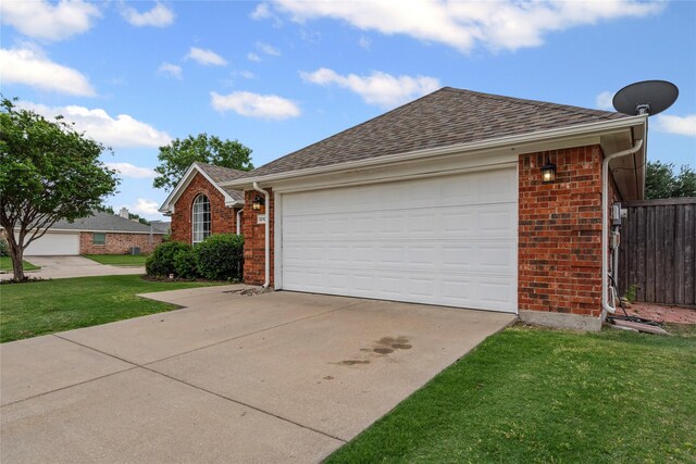 single story home with fence, an attached garage, brick siding, a front yard, and driveway