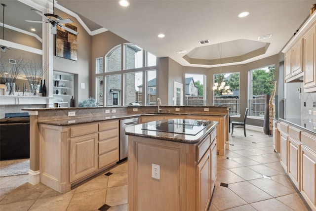 kitchen featuring light brown cabinetry, a sink, dishwasher, black electric cooktop, and a center island