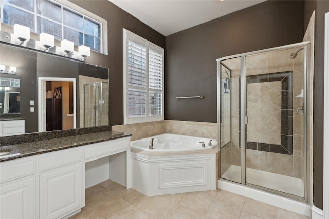 full bath with vanity, tile patterned flooring, a stall shower, and a garden tub