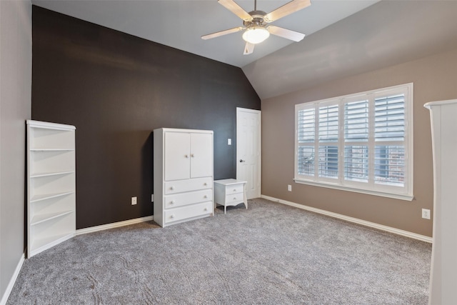 unfurnished bedroom featuring baseboards, carpet, and vaulted ceiling