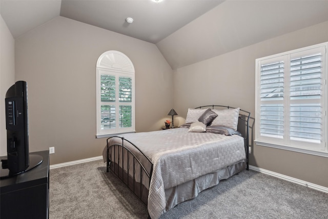 carpeted bedroom with baseboards and vaulted ceiling