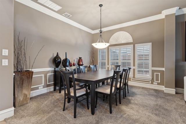 dining space featuring carpet floors, visible vents, and ornamental molding