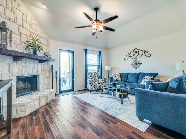 living room with ceiling fan, a fireplace, vaulted ceiling, wood finished floors, and baseboards