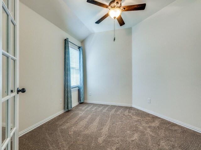 spare room with french doors, a ceiling fan, baseboards, lofted ceiling, and carpet