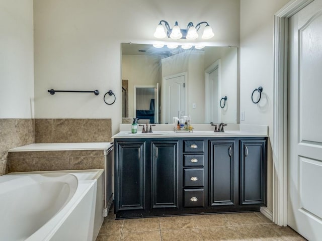 full bathroom featuring a sink, tile patterned floors, double vanity, and a bath