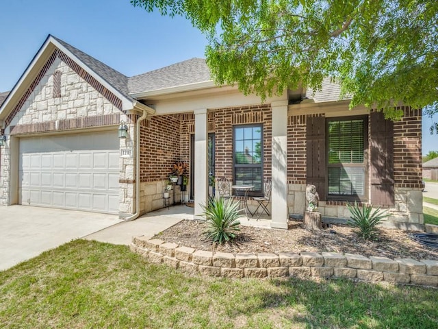 view of front of house featuring stone siding, brick siding, a shingled roof, an attached garage, and driveway