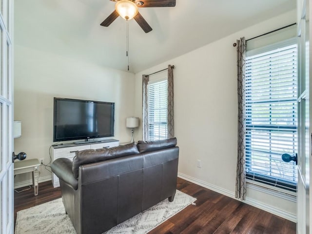 living room featuring baseboards, a ceiling fan, wood finished floors, and lofted ceiling