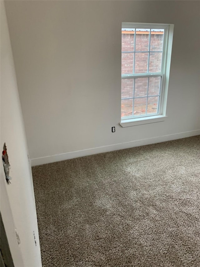 empty room with carpet floors and baseboards
