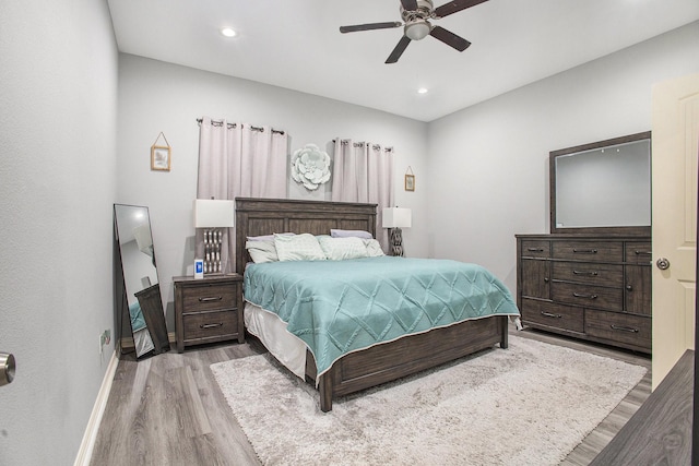 bedroom with wood finished floors, baseboards, recessed lighting, and a ceiling fan