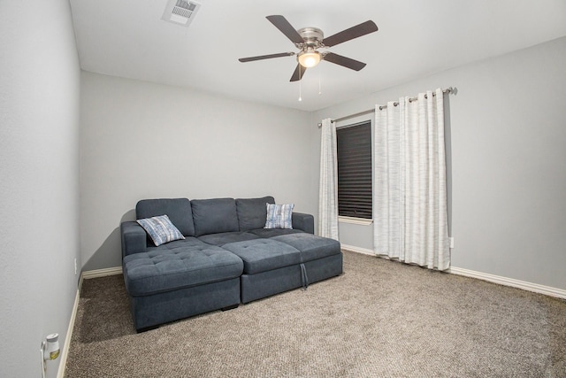 carpeted living area with ceiling fan and baseboards