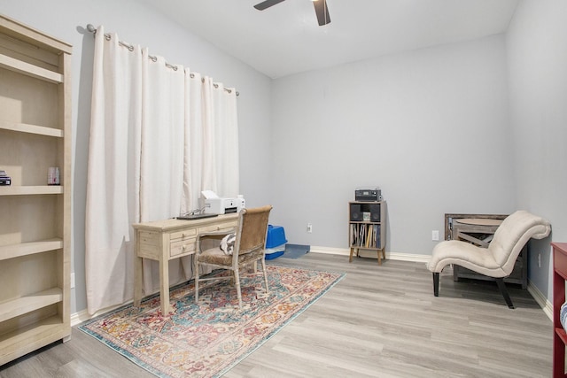 home office featuring ceiling fan, wood finished floors, and baseboards