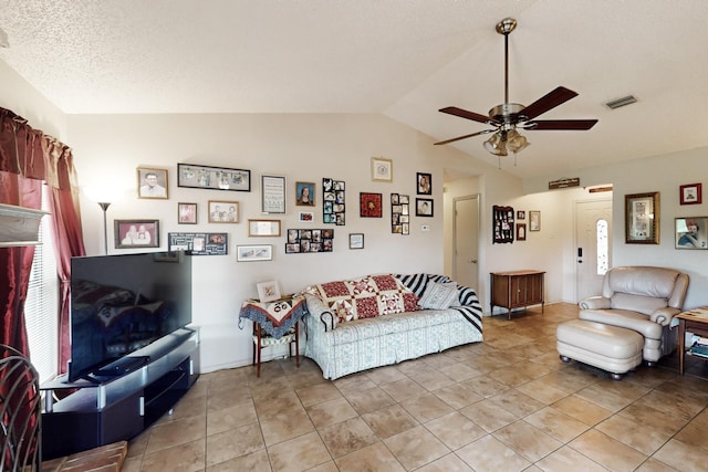 living area featuring light tile patterned floors, a ceiling fan, vaulted ceiling, and visible vents