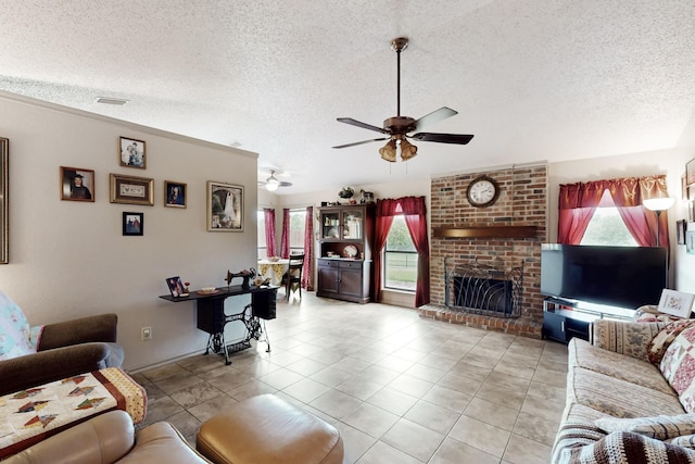 tiled living room with plenty of natural light, a textured ceiling, and ceiling fan
