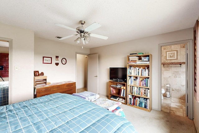 carpeted bedroom with visible vents, a textured ceiling, and ceiling fan