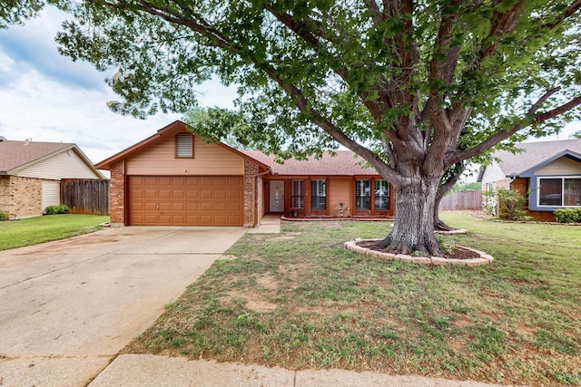 ranch-style home featuring concrete driveway, brick siding, an attached garage, and fence