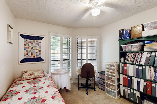 bedroom with carpet floors, a textured ceiling, and ceiling fan