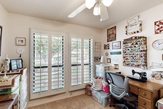 office area with ceiling fan, carpet flooring, and a textured ceiling