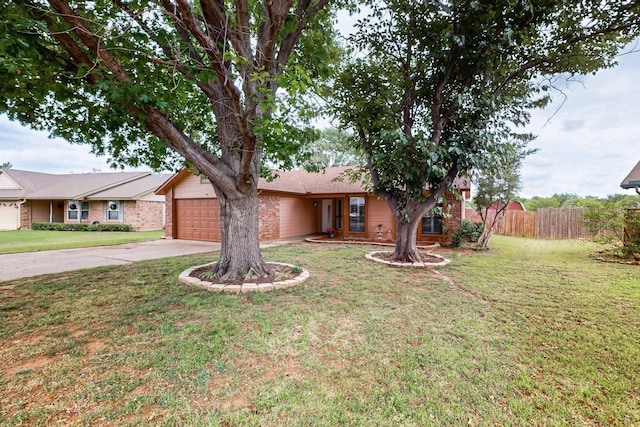 single story home with an attached garage, a front lawn, fence, and concrete driveway