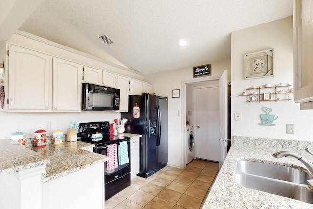 kitchen featuring white cabinets, a sink, washer / clothes dryer, visible vents, and black appliances