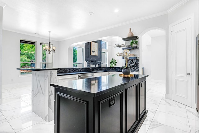 3401 Anthony Cir, Rowlett, TX 75088 - kitchen featuring arched walkways, dark cabinets, a chandelier, light marble finish floors, and ornamental molding