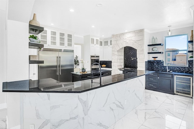 3401 Anthony Cir, Rowlett, TX 75088 - kitchen featuring appliances with stainless steel finishes, wine cooler, open shelves, decorative backsplash, and a sink