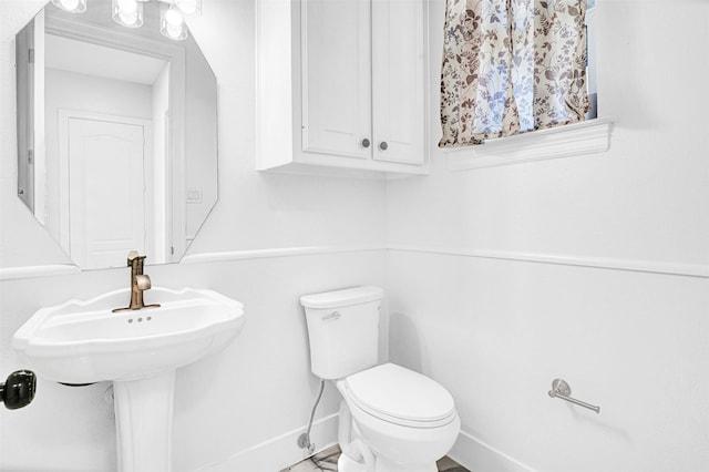 3401 Anthony Cir, Rowlett, TX 75088 - half bath featuring baseboards, toilet, and a sink