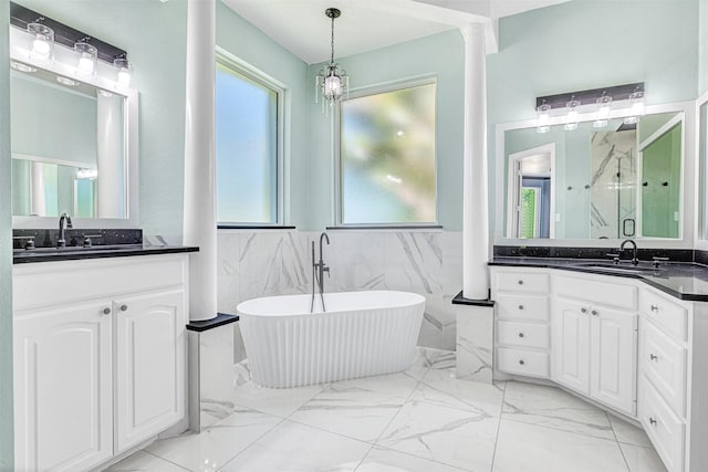 3401 Anthony Cir, Rowlett, TX 75088 - bathroom with marble finish floors, plenty of natural light, a marble finish shower, tile walls, and a soaking tub