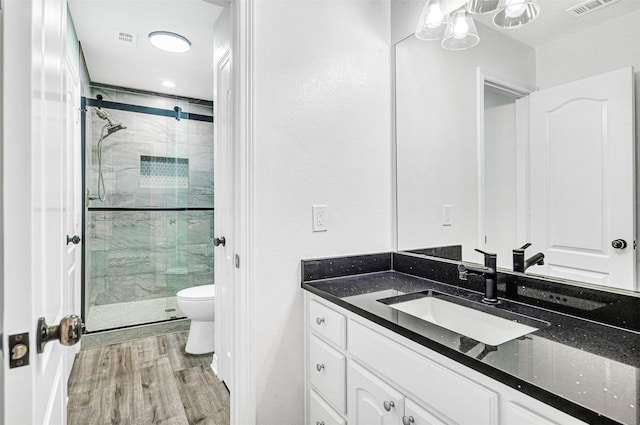3401 Anthony Cir, Rowlett, TX 75088 - full bathroom featuring toilet, a shower stall, vanity, and wood finished floors