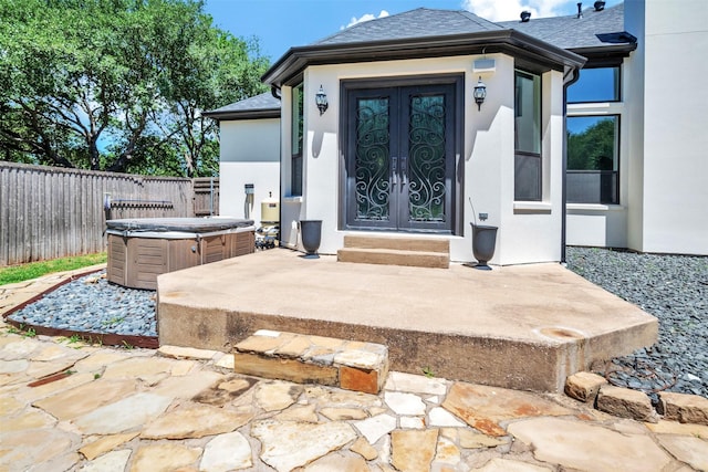 3401 Anthony Cir, Rowlett, TX 75088 - view of exterior entry featuring french doors, a hot tub, stucco siding, and roof with shingles