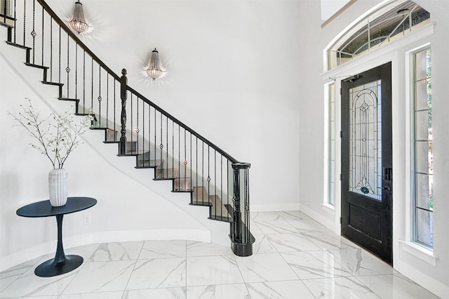 3401 Anthony Cir, Rowlett, TX 75088 - entryway with baseboards, marble finish floors, stairs, and a high ceiling