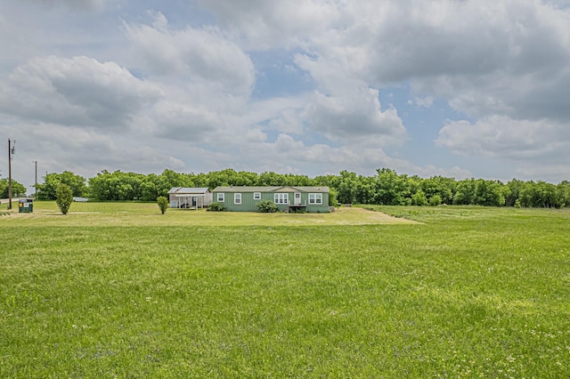 view of yard with a rural view