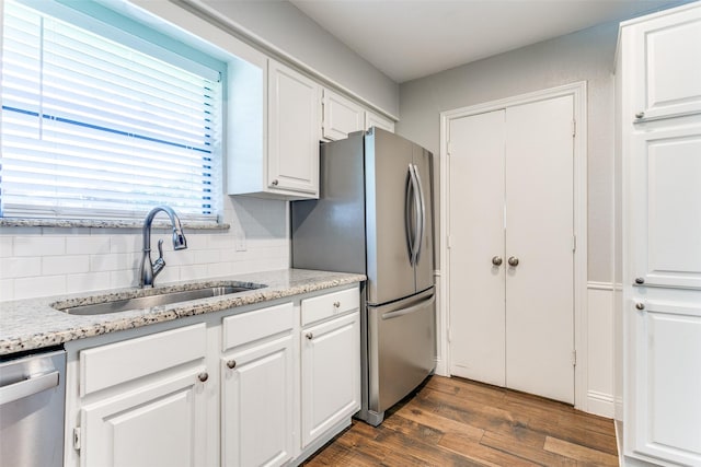 19 Salida Dr, Trophy Club, TX 76262 - kitchen featuring a sink, appliances with stainless steel finishes, white cabinets, dark wood-type flooring, and decorative backsplash
