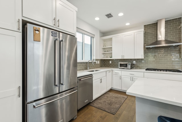5424 Anita St, Dallas, TX 75206 - kitchen with stainless steel appliances, a sink, wall chimney exhaust hood, open shelves, and white cabinetry