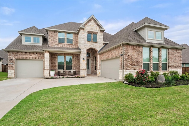 2812 Bluff Creek Dr, Mansfield, TX 76063 - view of front of home with roof with shingles, a front yard, driveway, and brick siding