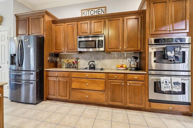 kitchen with brown cabinets, stainless steel appliances, ornamental molding, and tasteful backsplash