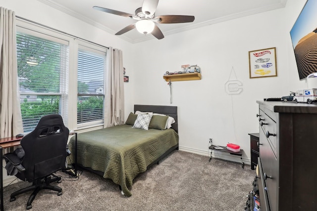 carpeted bedroom with crown molding, a ceiling fan, and baseboards