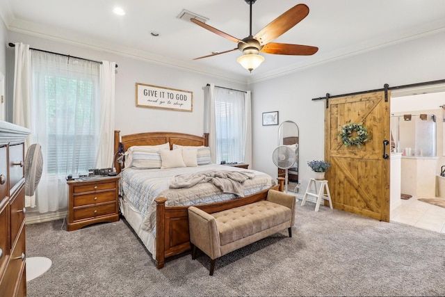 carpeted bedroom featuring connected bathroom, ceiling fan, a barn door, visible vents, and ornamental molding