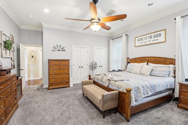 bedroom with crown molding, carpet flooring, two closets, recessed lighting, and visible vents