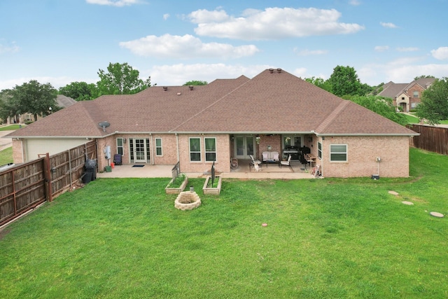back of house featuring a shingled roof, a fenced backyard, a patio area, french doors, and a yard