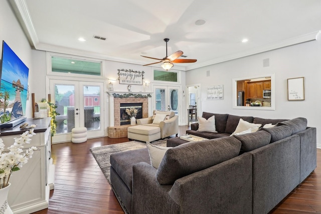 living area with ceiling fan, visible vents, ornamental molding, and french doors
